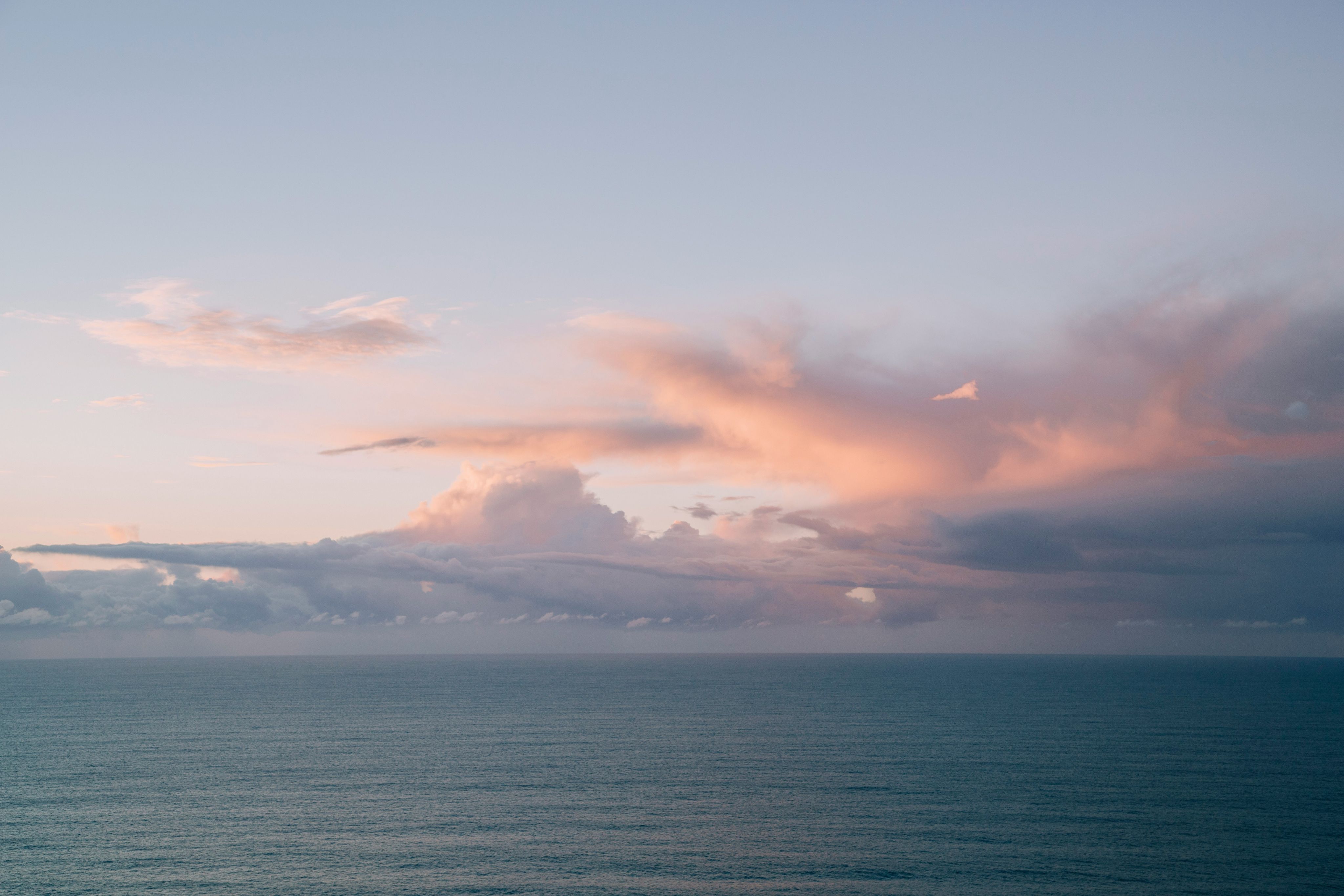 Jade Stephens Unsplash - Clouds over a sea background image.